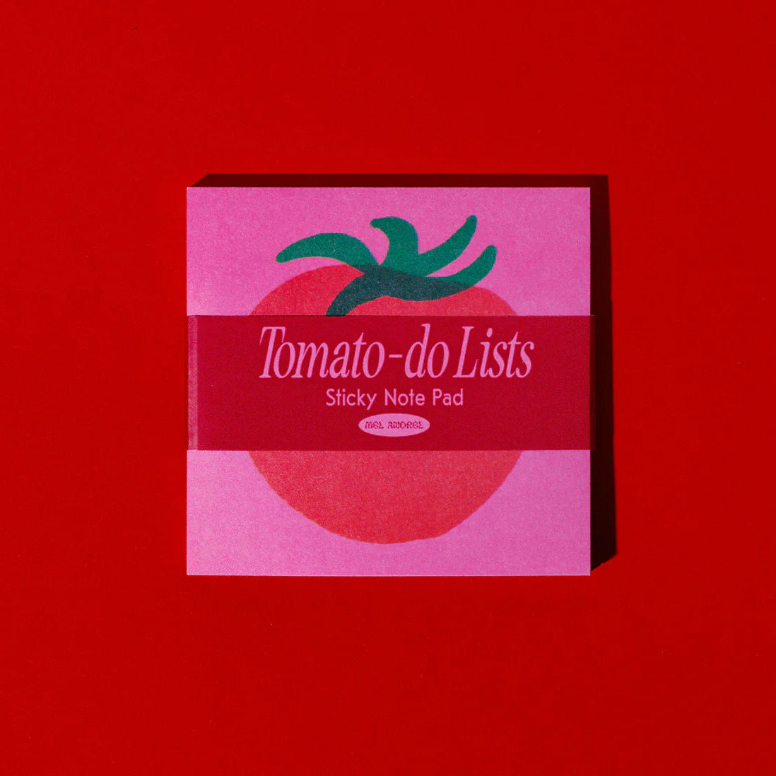 Pink 'Tomato-do Lists' sticky note pad with green leaf design on a red background