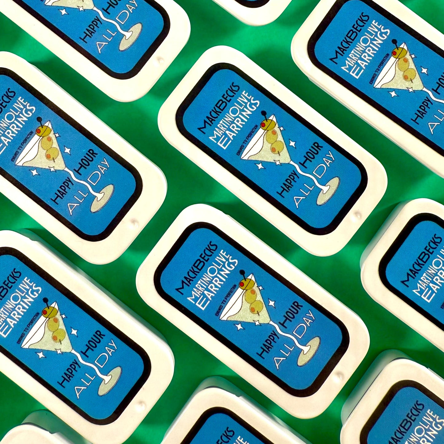 MackBecks custom Martini Olive Tinned Earrings on a green background