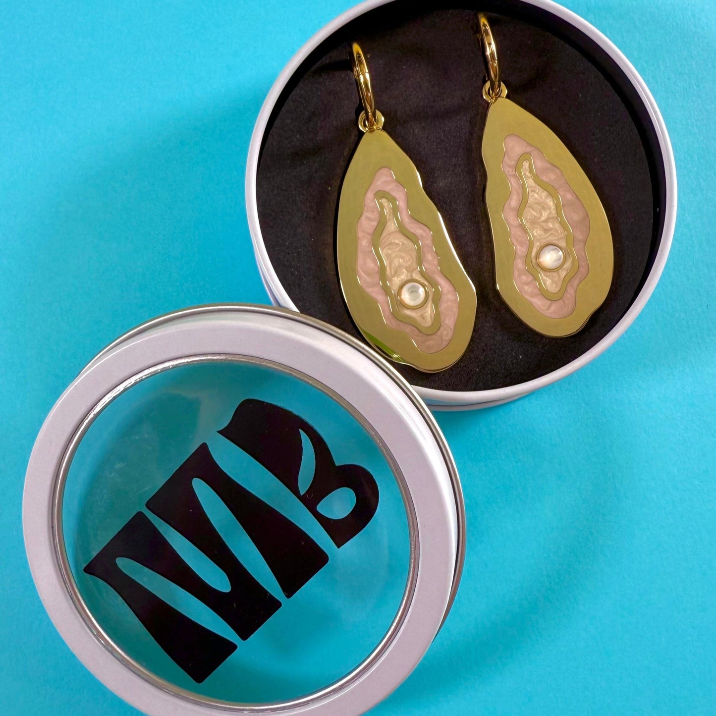 MackBecks Gold Oyster Earrings with pink enamel details and a pearlescent cabochon in MackBecks custom circle white window in.