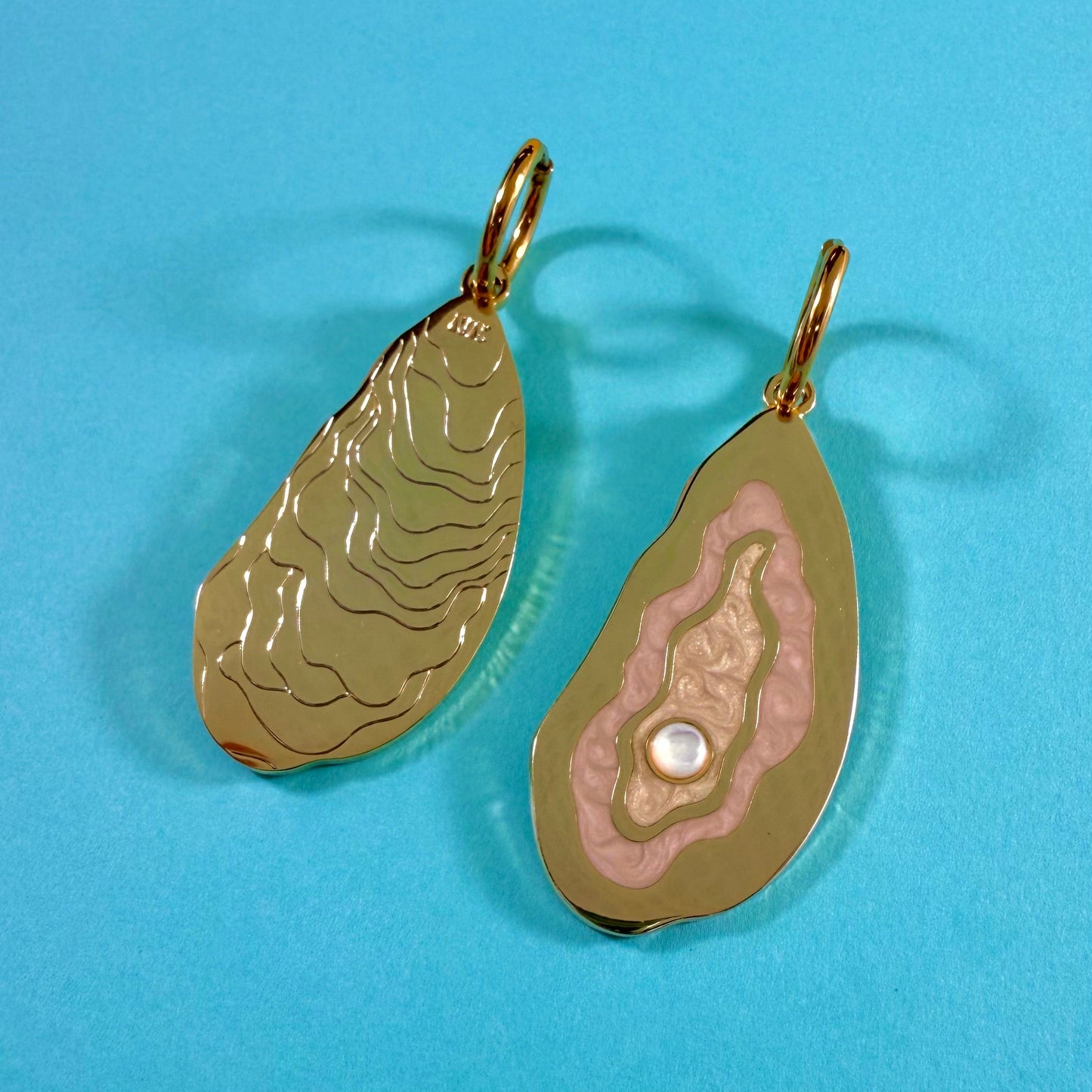 MackBecks Gold Oyster Earrings with pink enamel details and a pearlescent cabochon showing both sides of the earring.