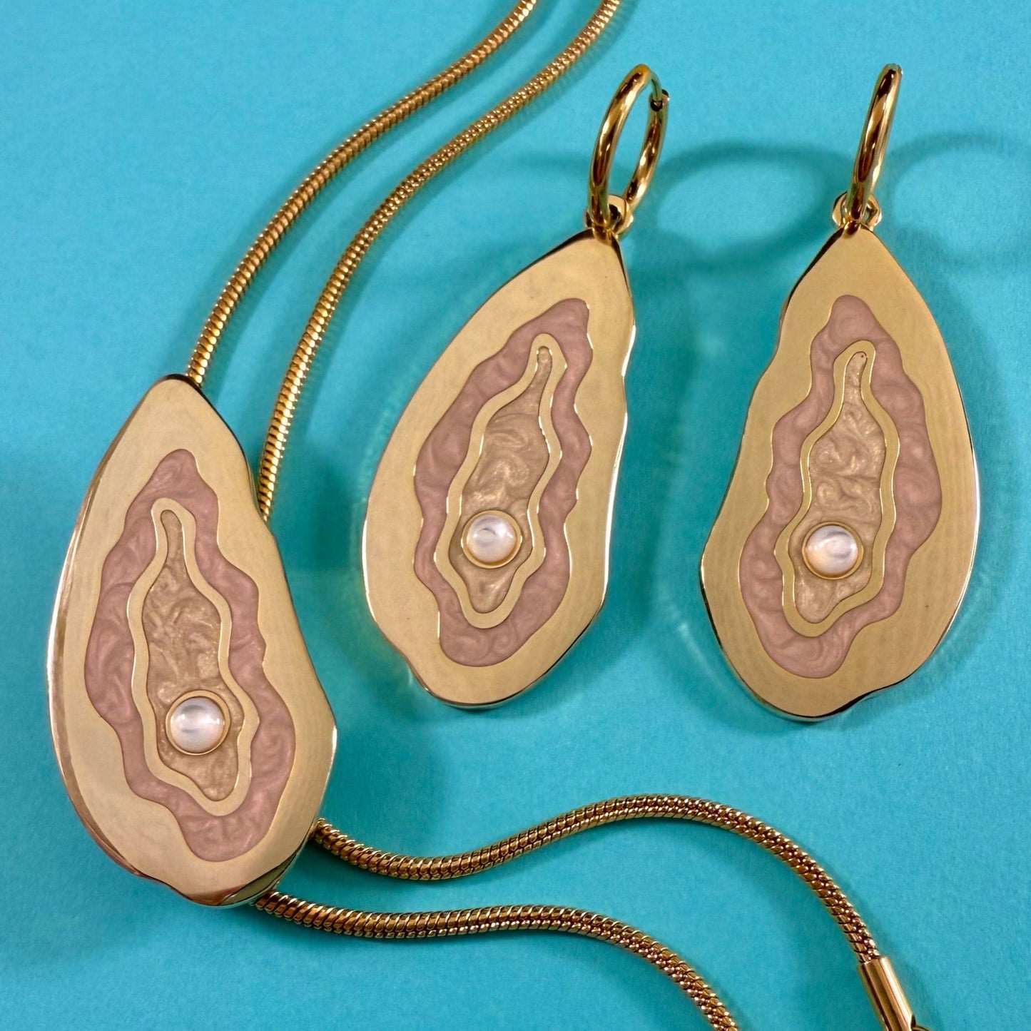 MackBecks Gold-Plated Oyster Bolo and Earring set on teal background.