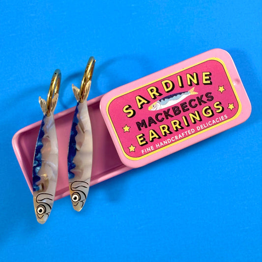 MackBecks Original Sardine Earrings in a Pink Retro Tin on a blue background.